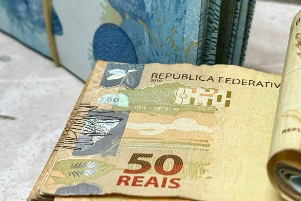 Salário líquido: como calcular os descontos de INSS e IR em 2026 1 Notas de 50 e 100 reais empilhadas, em foto ilustrativa