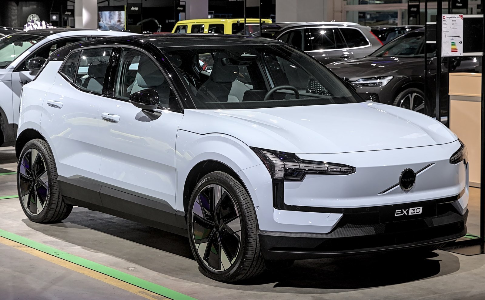 SUV elétrico Volvo EX30 branco-azulado exposto em um salão do automóvel